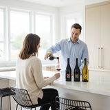Man pouring wine for a woman in a modern kitchen