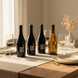 Wine bottles and glasses on a table with a neutral background